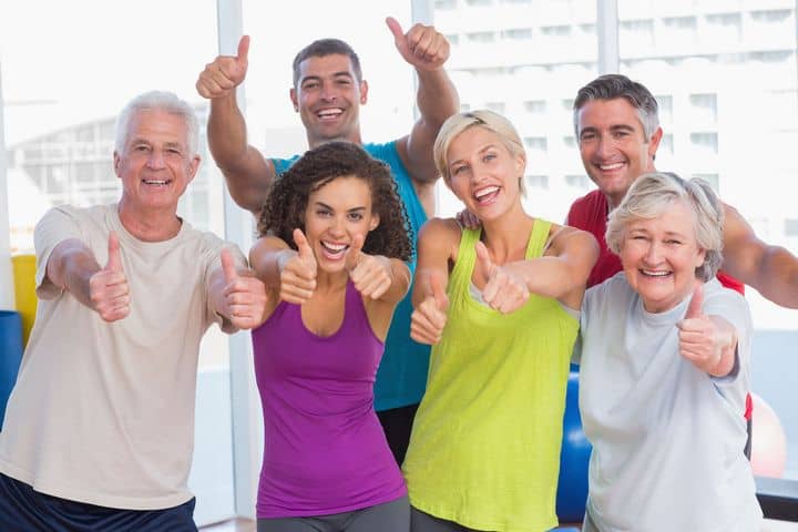 younger and older exercisers showing a thumbs-up sign